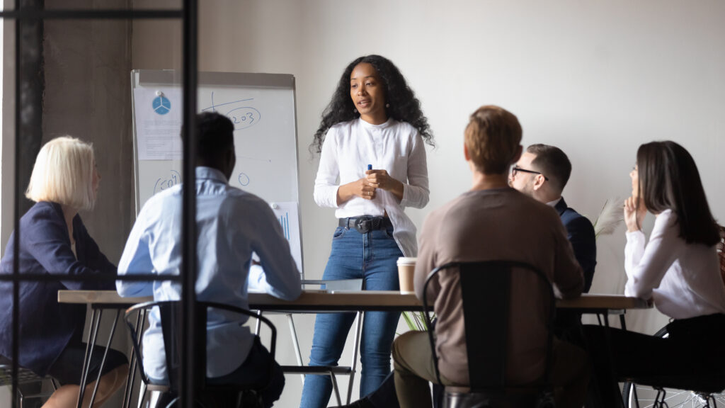 African Ethnicity Woman Presenter Makes Presentation For Multiethnic Audience Businesspeople