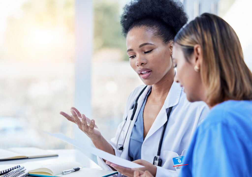 Collaboration, Doctor And Nurse In Discussion Of Paperwork Or Prescription In A Hospital Or Clinic Feeling Planning. Partnership, Medical And Healthcare Professional Workers Or Colleagues Working